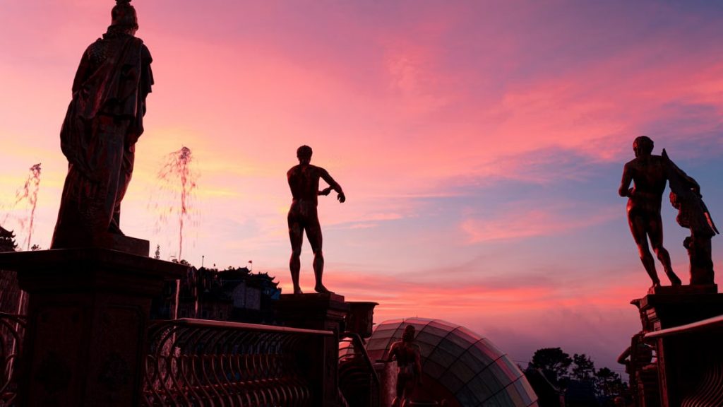 Majestic statue silhouettes against a vibrant sunset sky in Đà Nẵng, Vietnam.